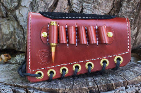 A reddish-brown leather rifle butt cuff handmade is Wisconsin. For hunters and trap shooters.